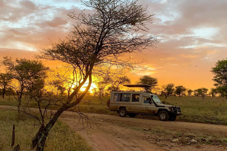 Family enjoying safari in Serengeti National Park, Tanzania